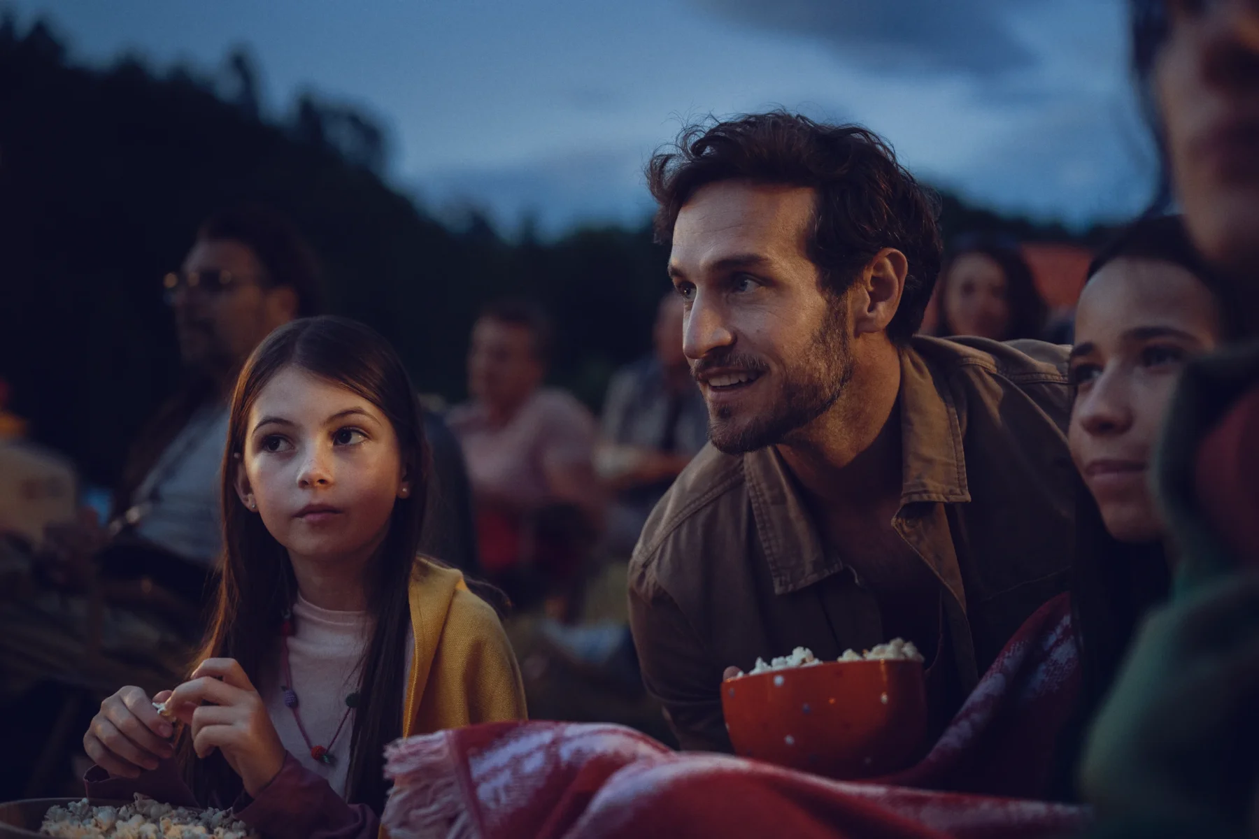 portrait of a family watching a movie outdoor
